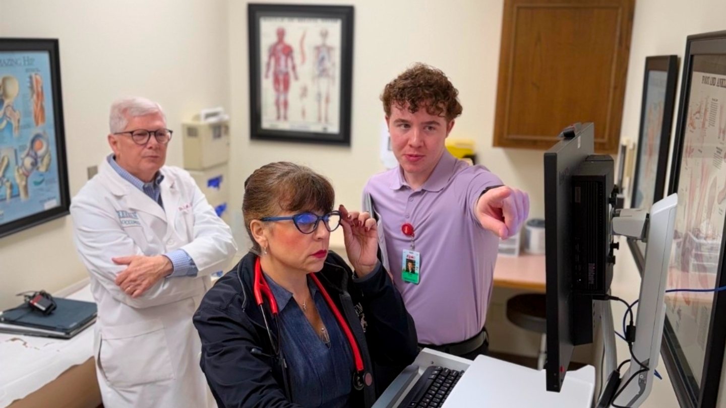 Dr. Estep and Natalie Davenport of Occupational Medicine working through a visit in Epic with Adam of the Epic team at a Workflow Dress Rehearsal