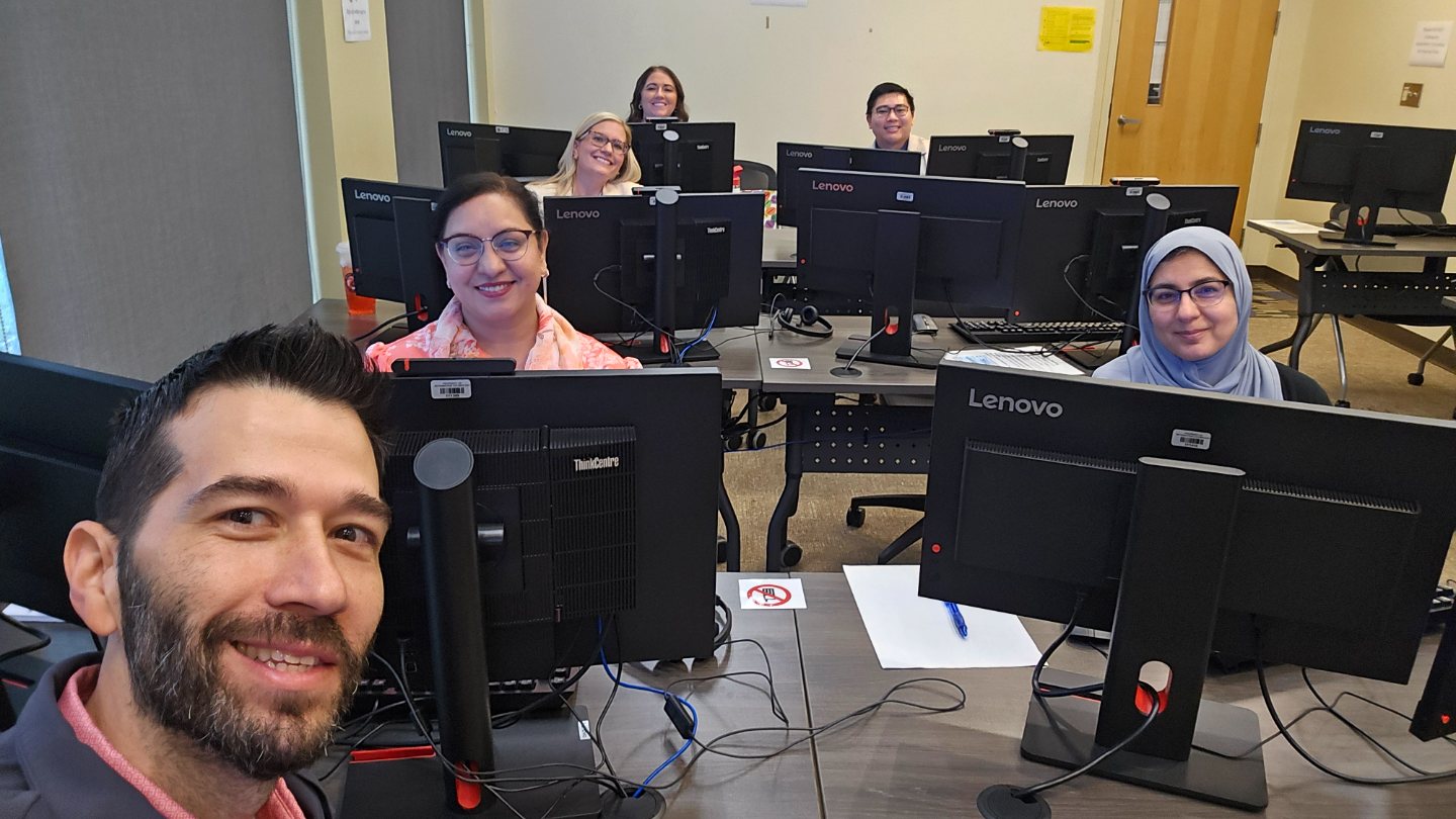Hospitalists smiling at their workstations during Epic training